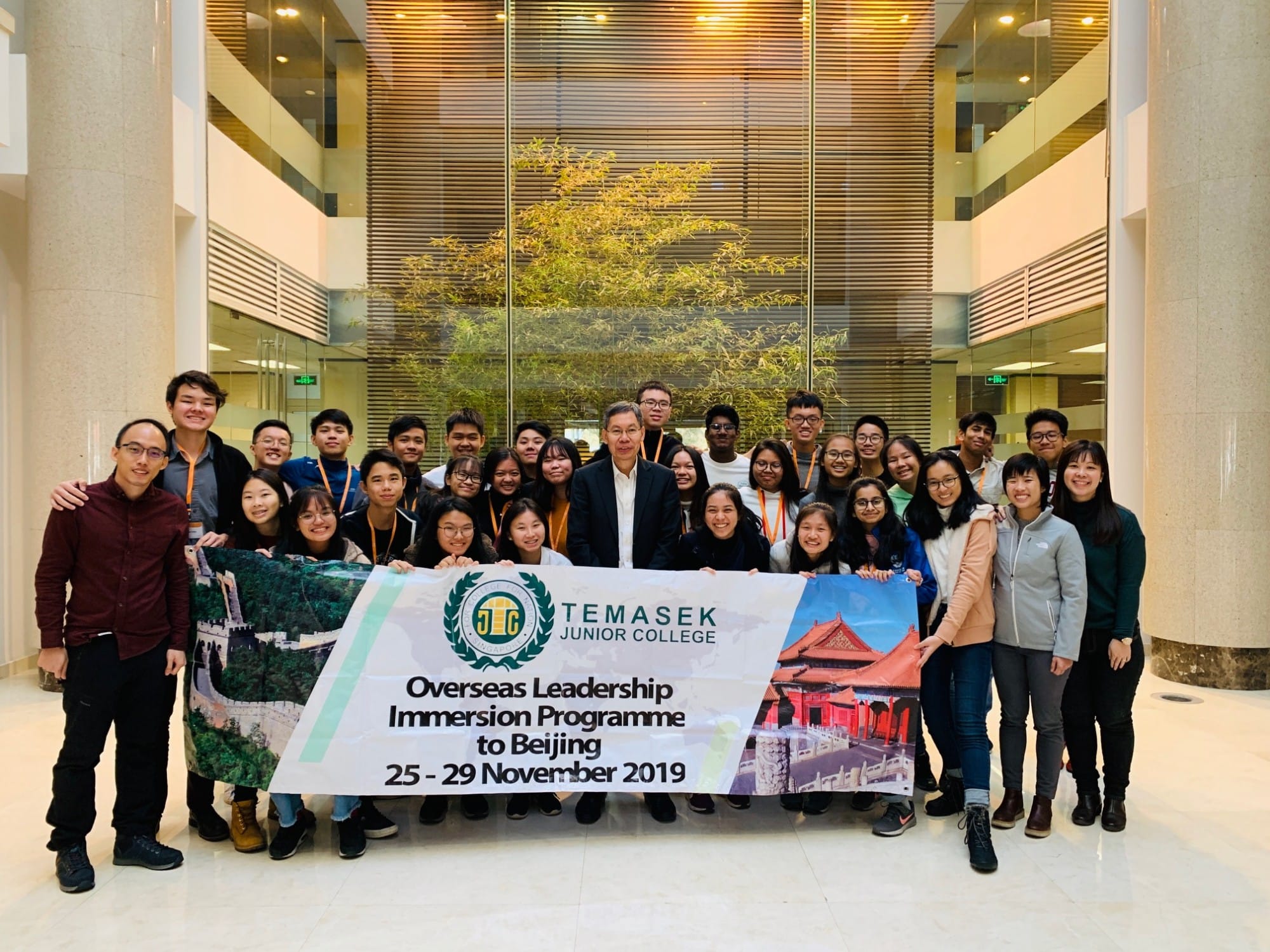 Group of students and teachers holding a Temasek Junior College Beijing Leadership Immersion Programme banner, November 2019.